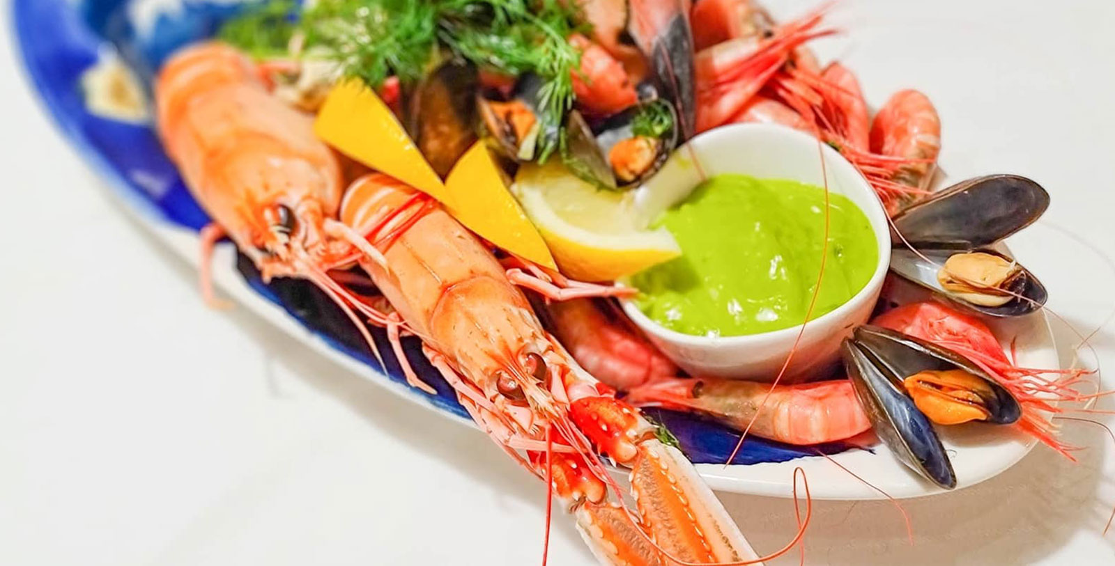 a plate of seafood with a sauce
