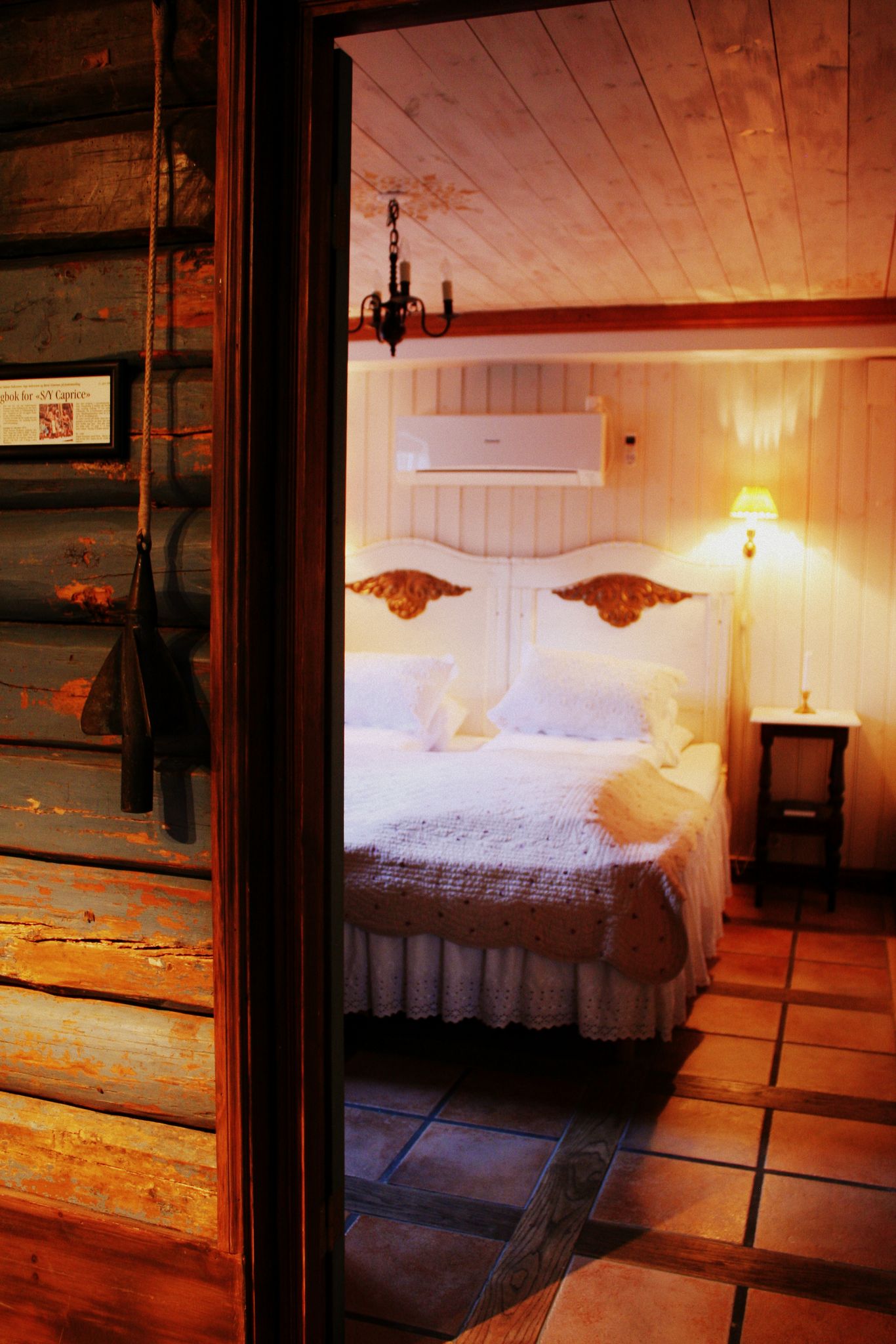 a room with a bed and a lamp
