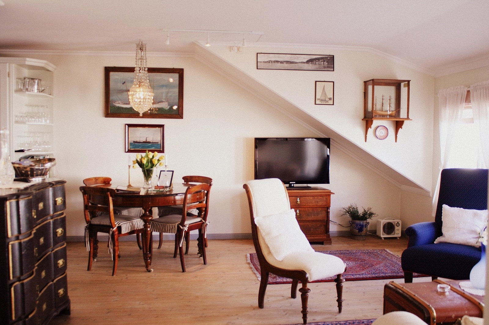 a living room with a table and chairs