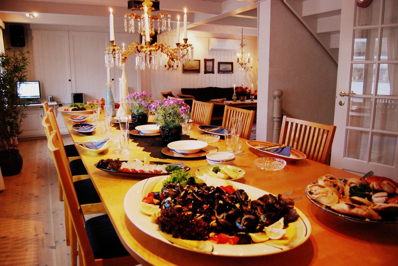 a table with plates of food and flowers on it
