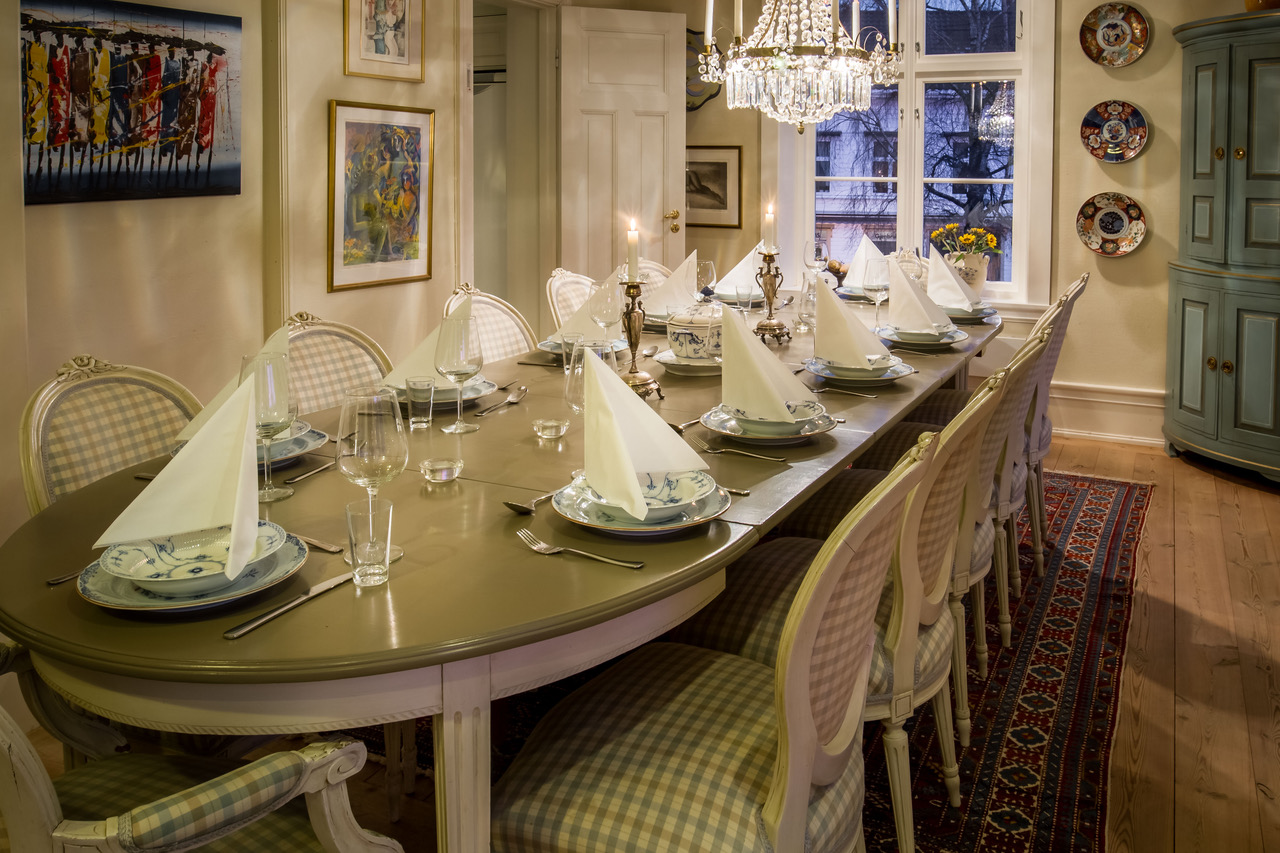 a dining table with plates and glasses