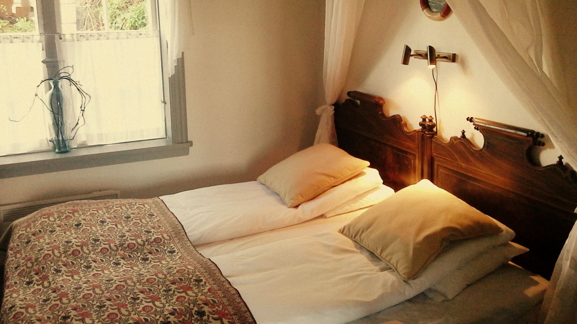 a bed with pillows and a lamp