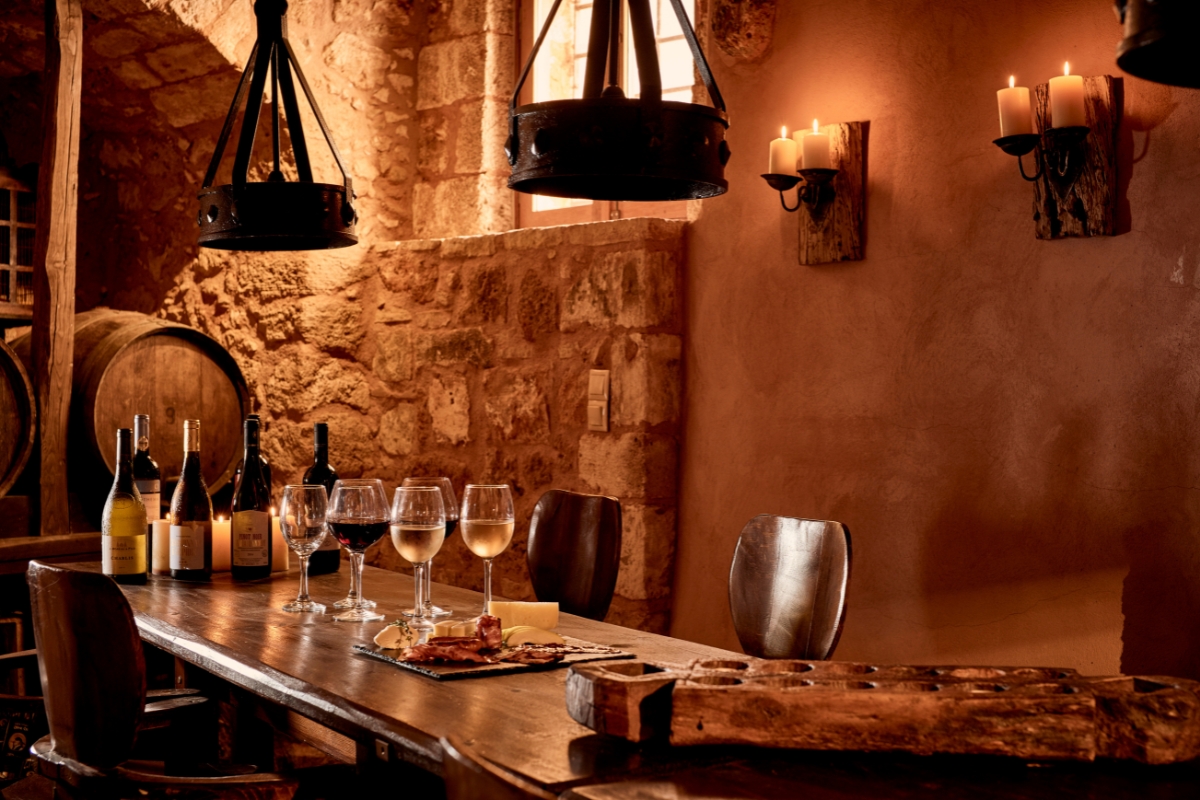 a table with wine glasses and bottles of wine