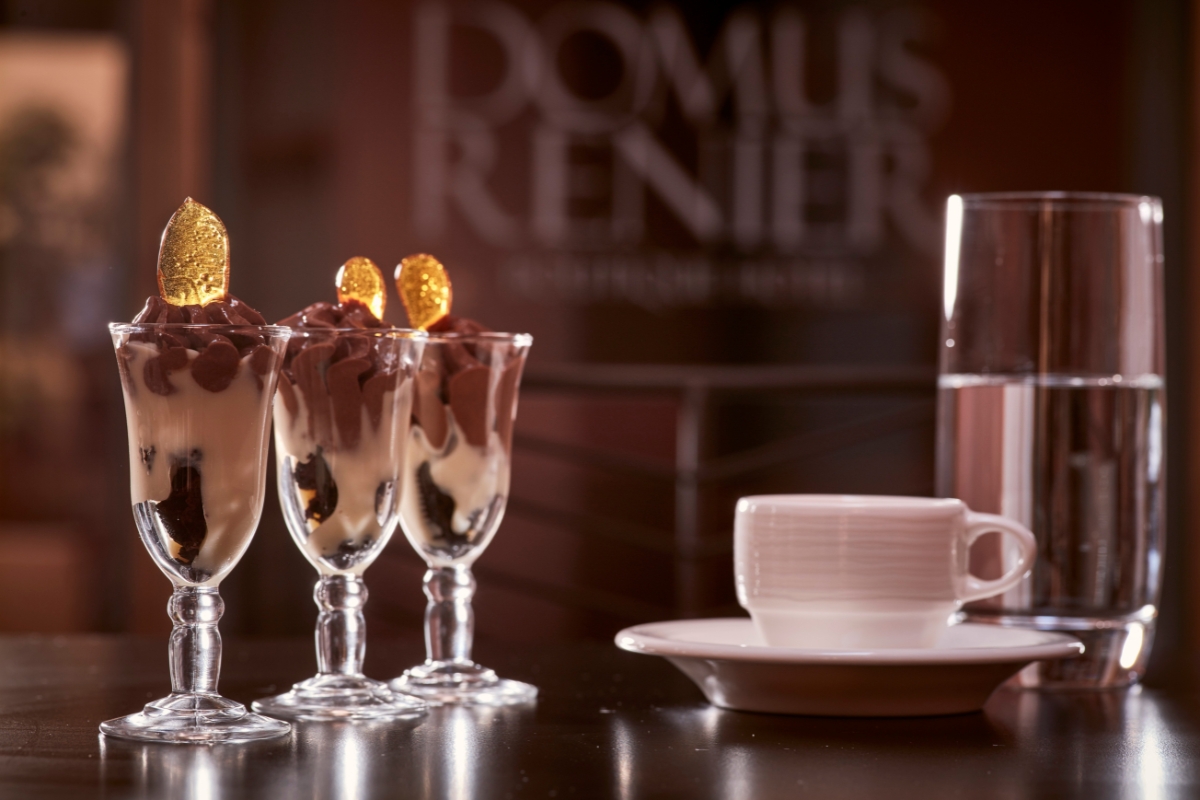 a group of desserts in glasses
