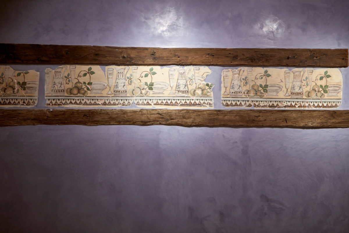 a wall with a piece of wood and a piece of art