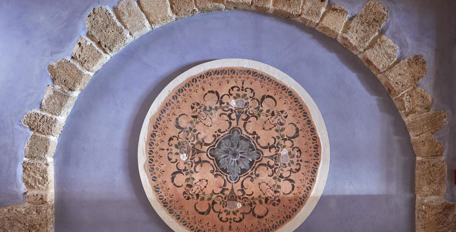 a circular object with a design on the wall