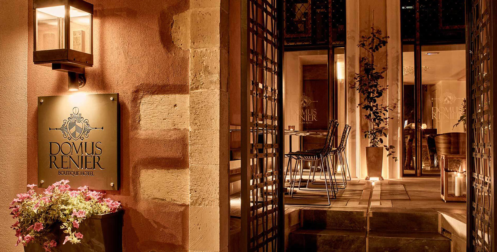 a stone wall with a screen and chairs