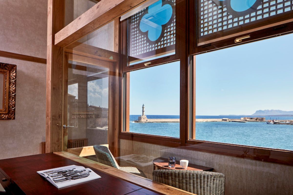 a table with chairs and a table with a view of the ocean