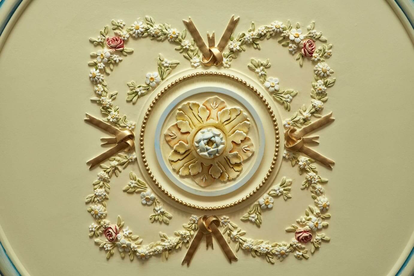 a decorative ceiling with flowers and ribbons