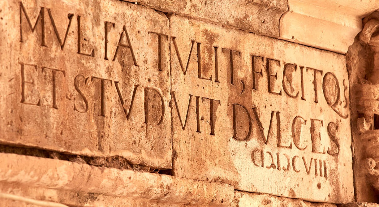 a stone wall with engraved text