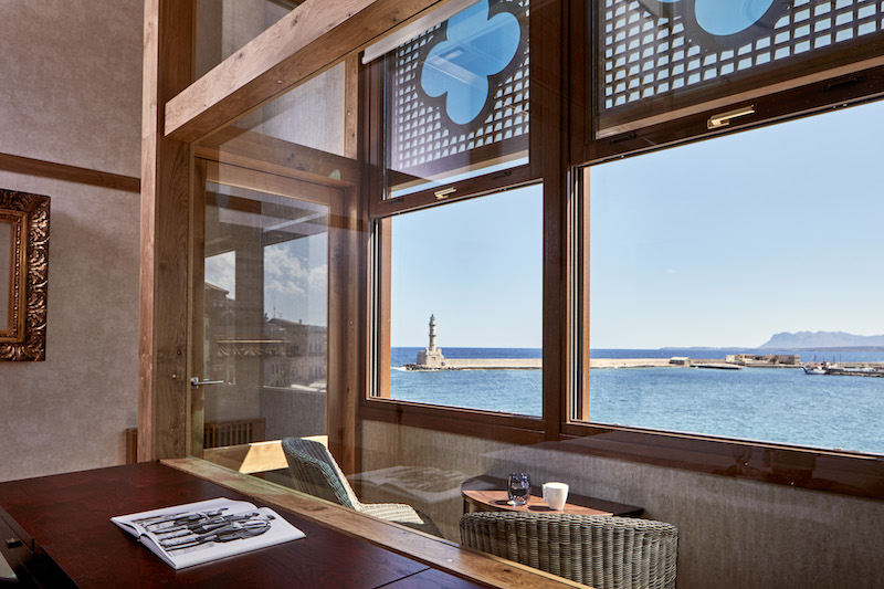 a table with chairs and a table with a view of the ocean