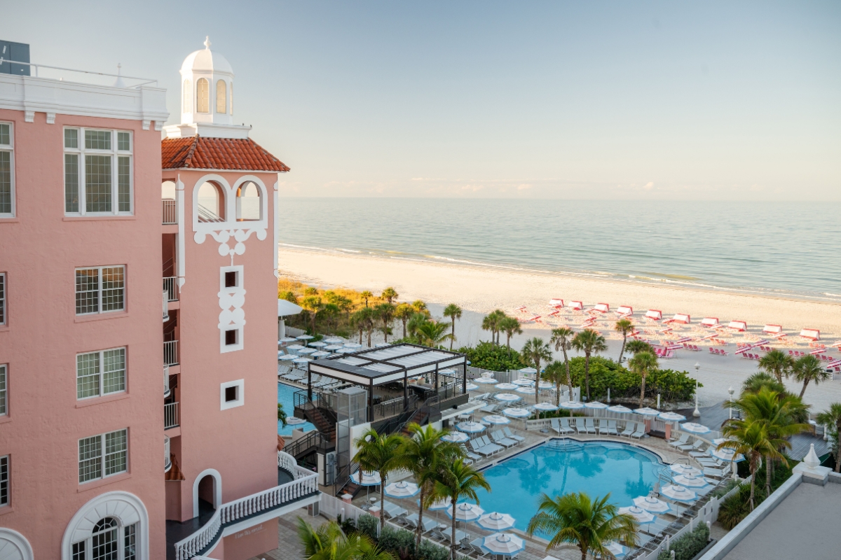a hotel with a pool and palm trees