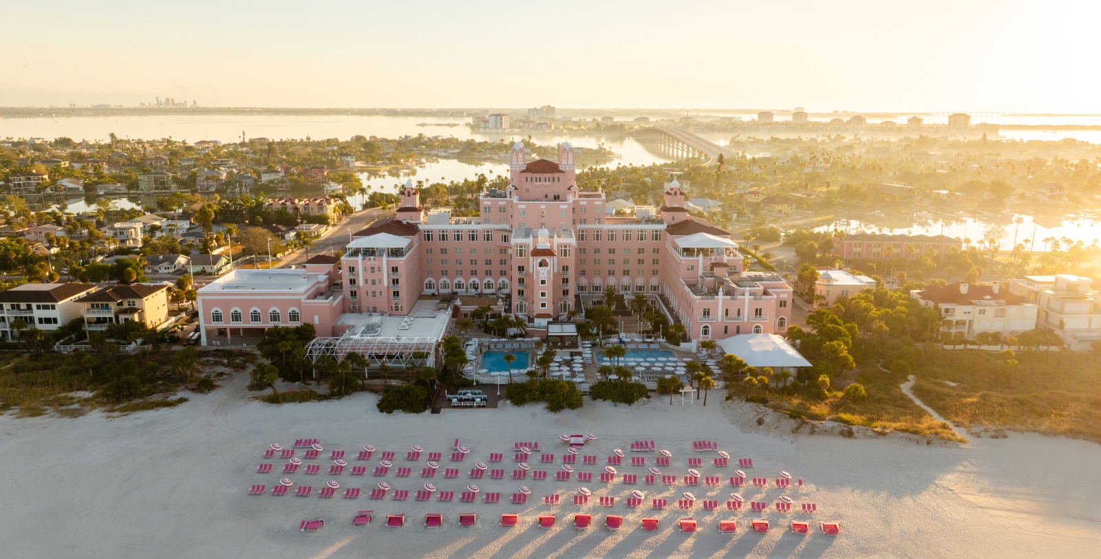 a large building with many chairs on a beach