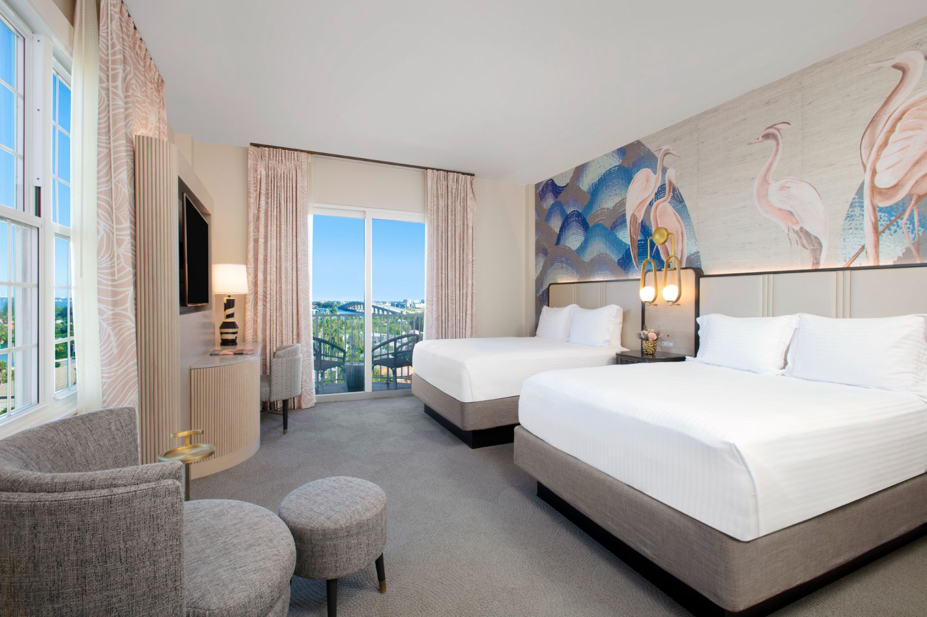 a room with two beds and a television