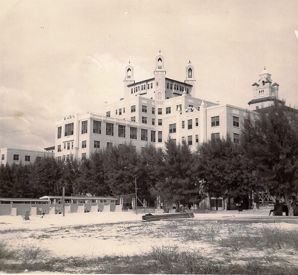 a large building with trees in front
