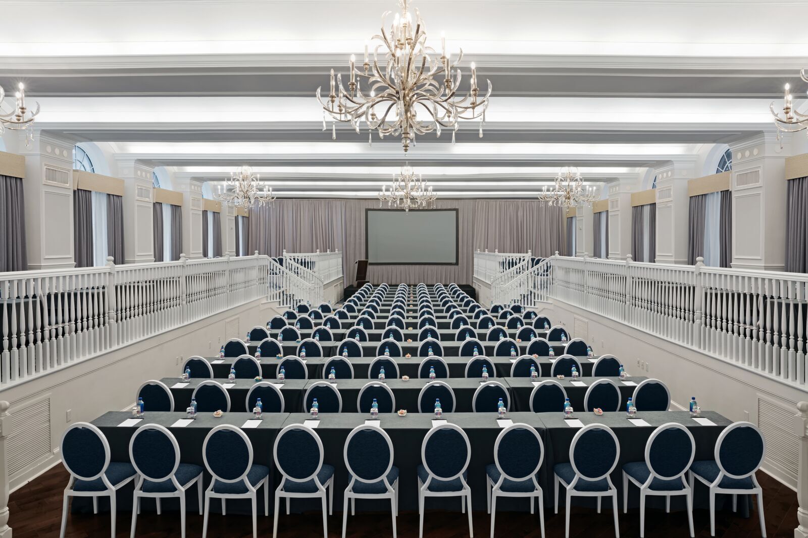 a room with long tables and chairs