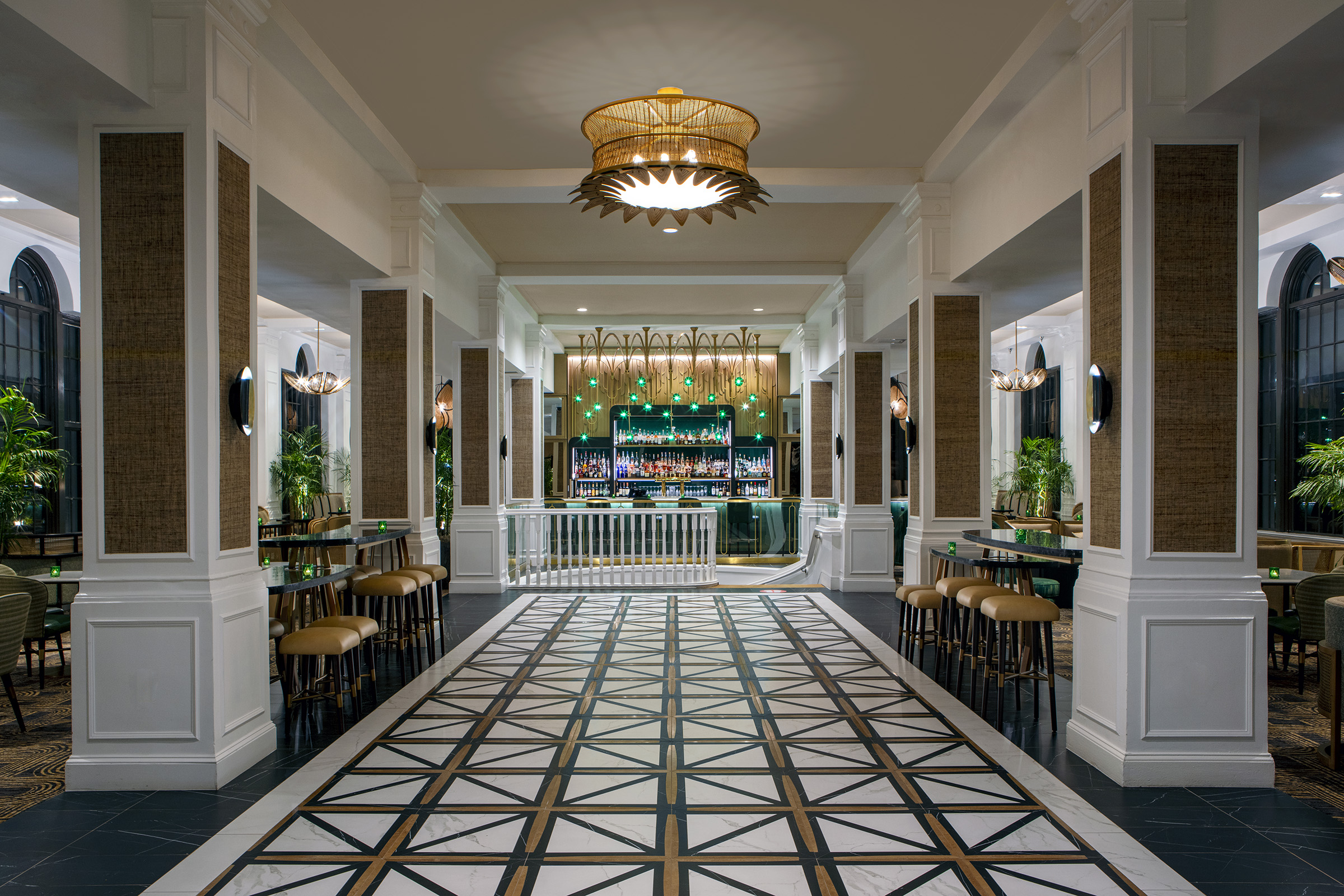 a room with a bar and a chandelier