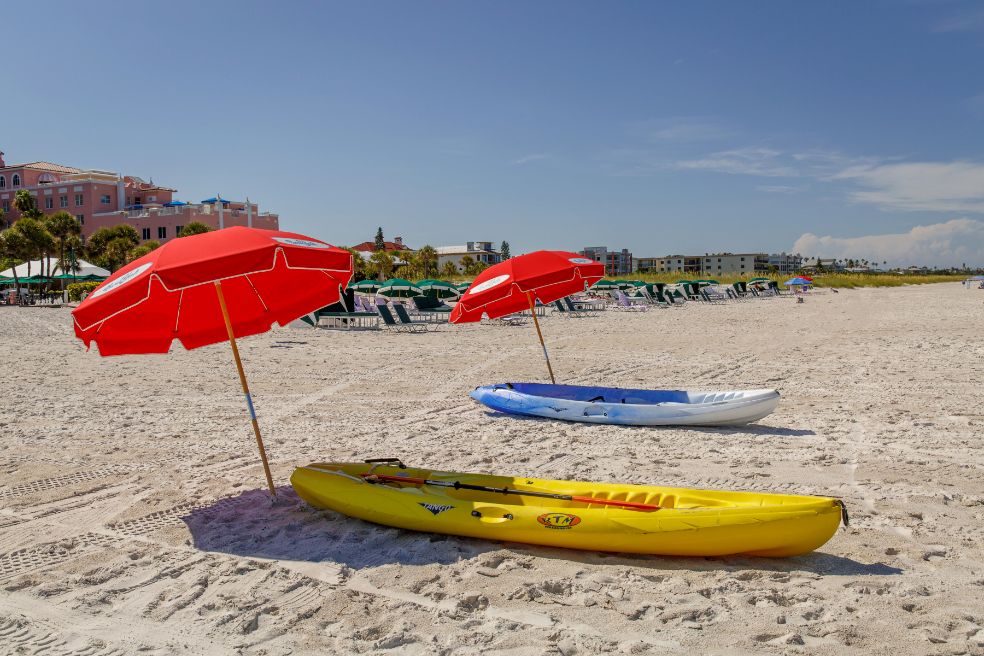 a group of boats and umbrellas on a beach