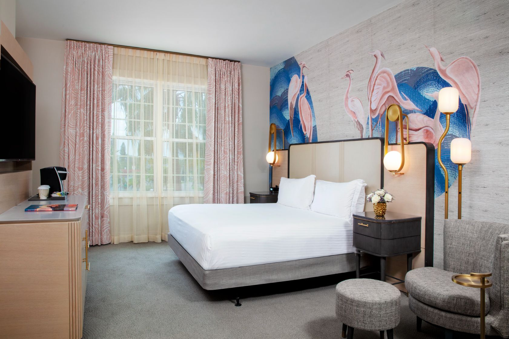 a room with a bed and pink curtains