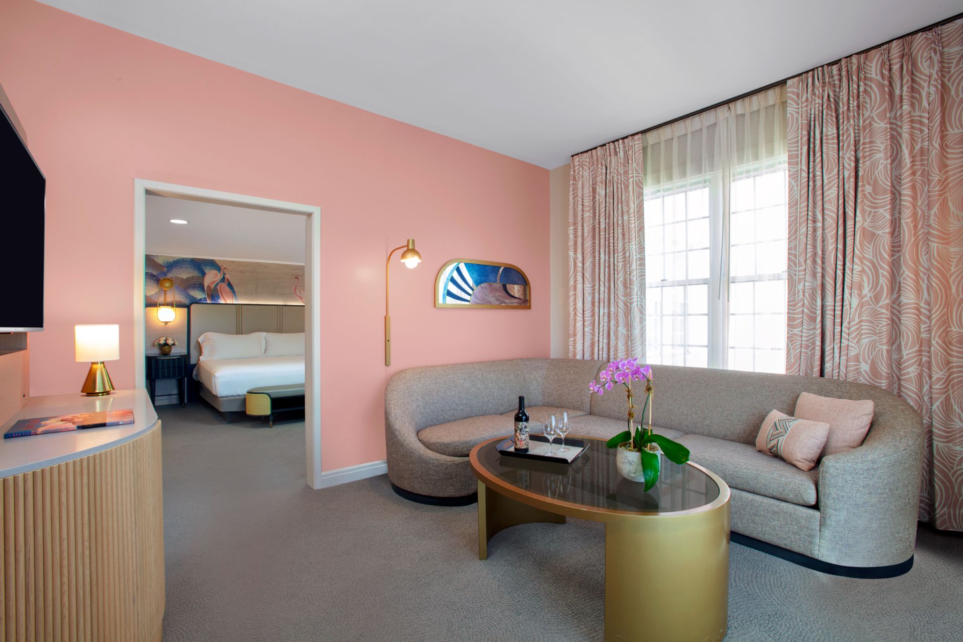 a room with pink walls and a couch and a coffee table