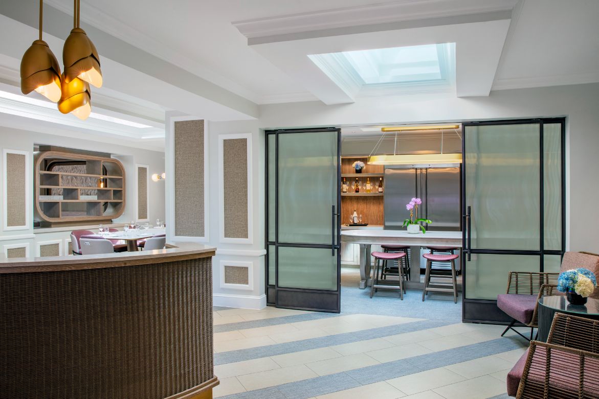a room with a kitchen and dining area
