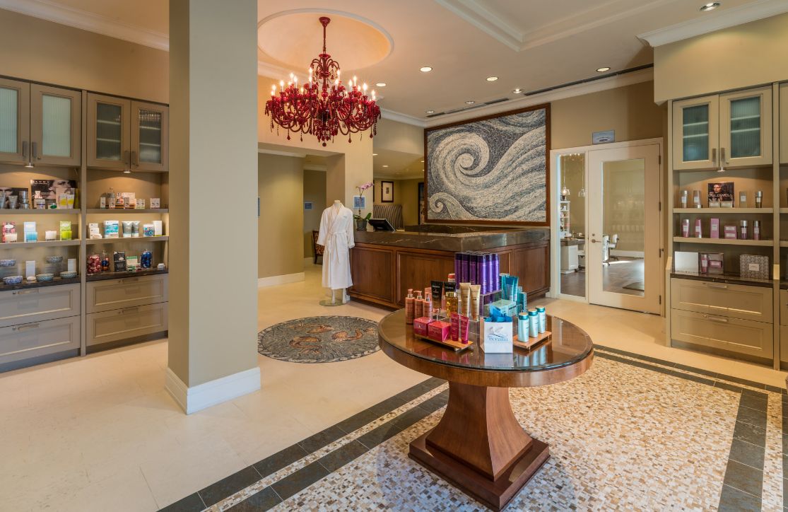 a room with a red chandelier and a table with products