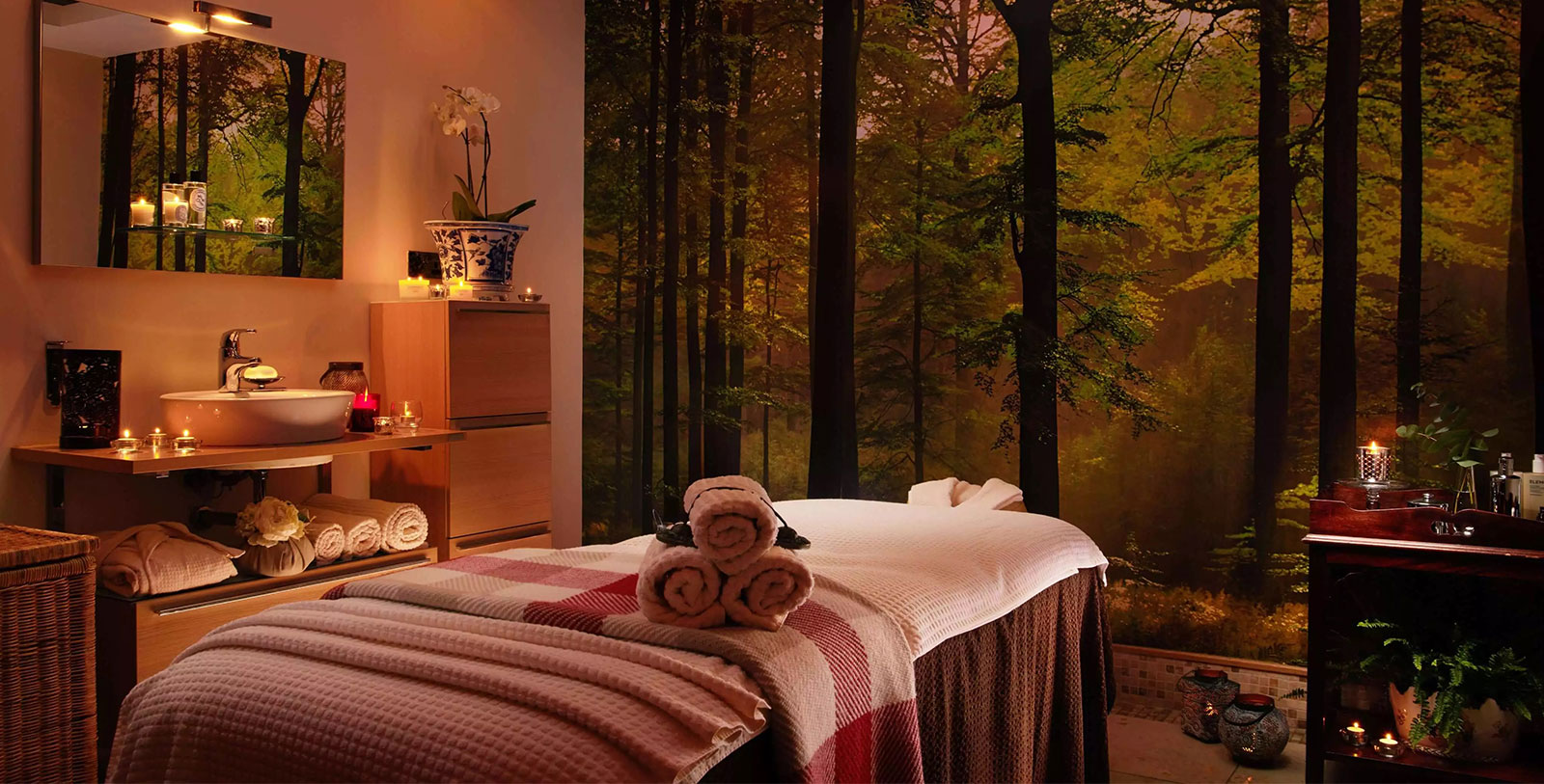 a massage table with towels and candles