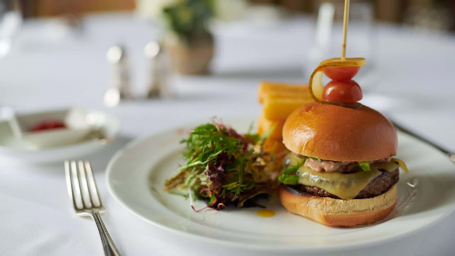a burger and salad on a plate