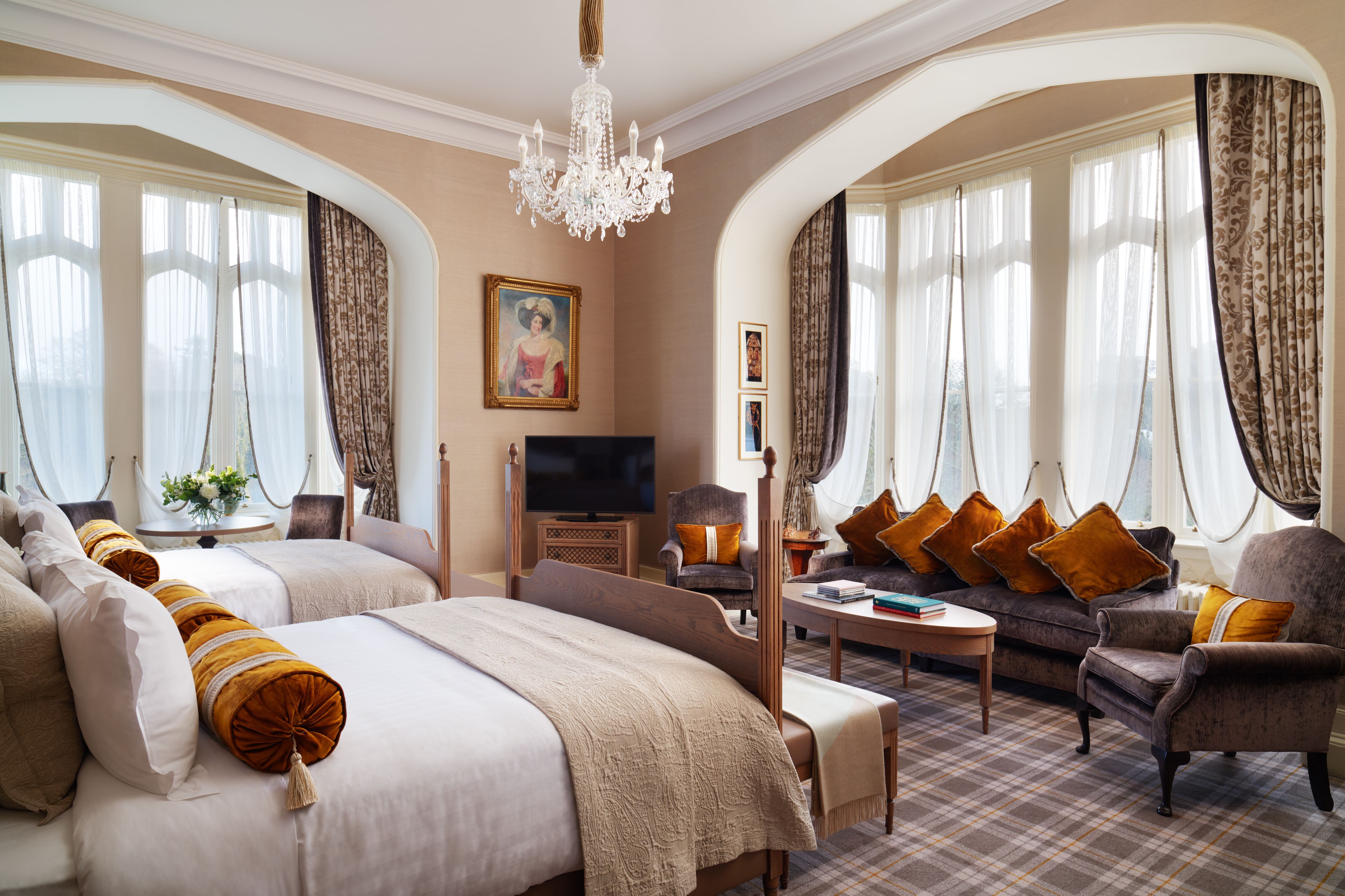 a room with two beds and a couch