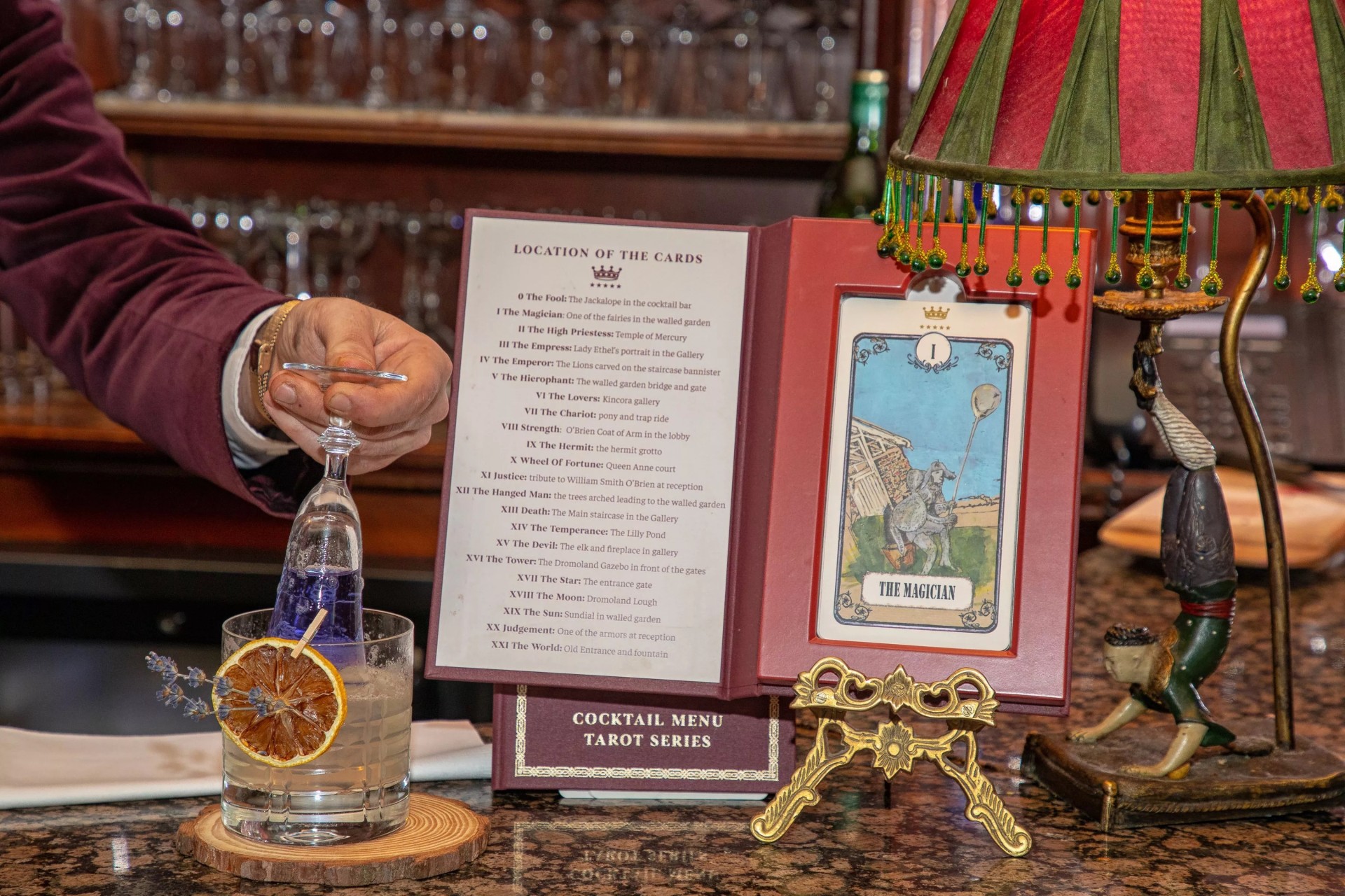 a hand holding a drink in a glass