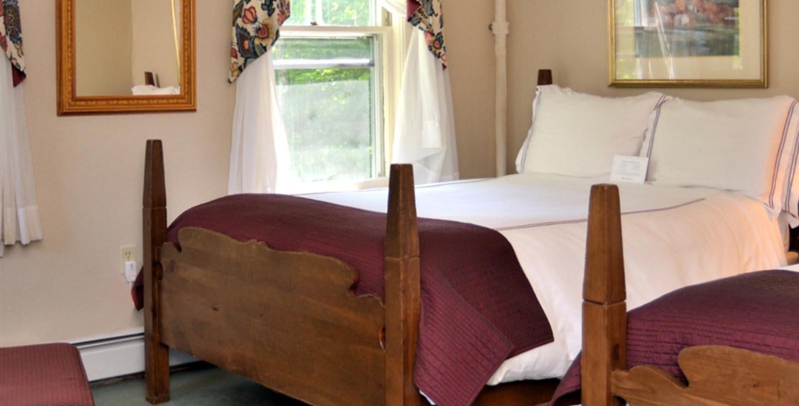 a bed with a red blanket and a window