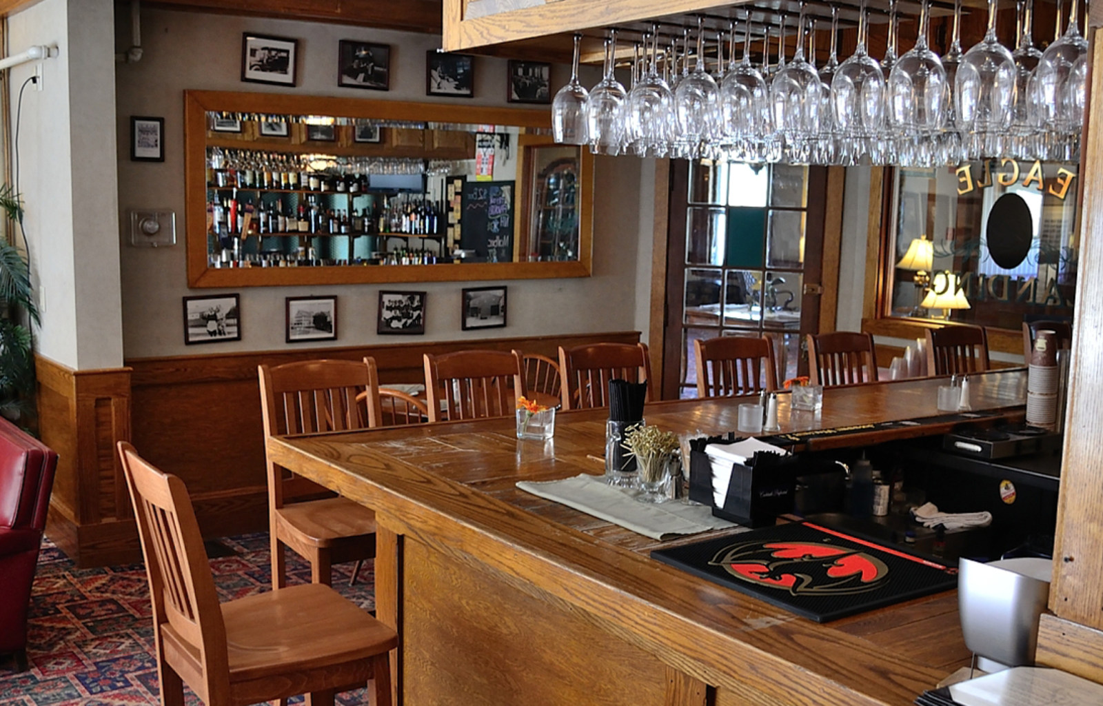 a bar with wine glasses from the ceiling
