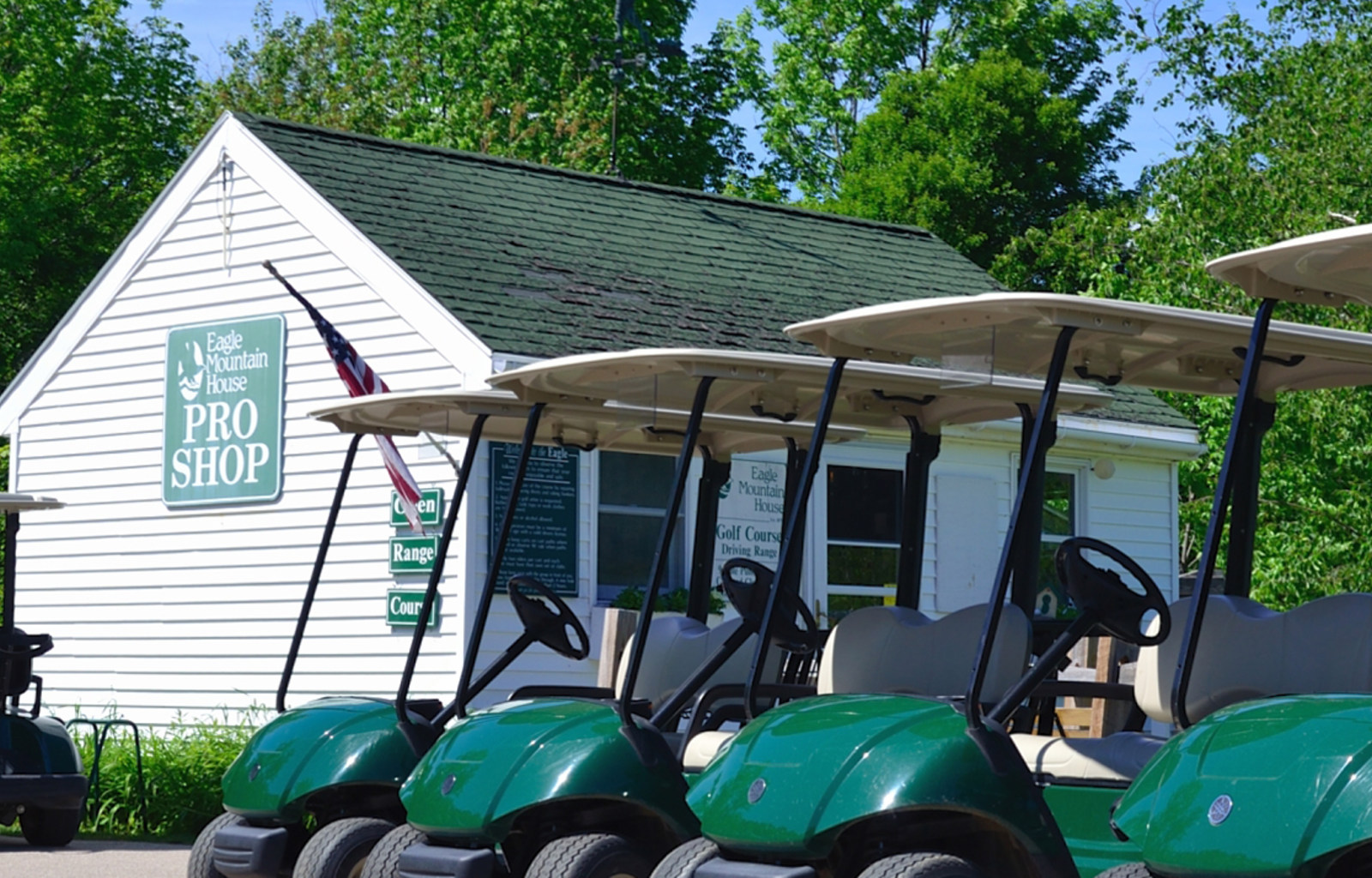 a group of golf carts parked in front of a building