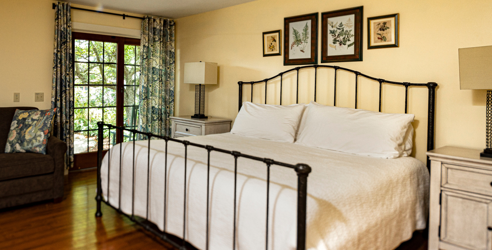 a bed with white sheets and a lamp on the side