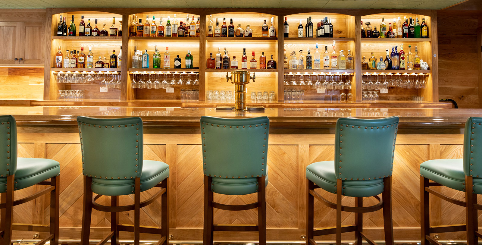 a bar with a row of chairs and a beer tap
