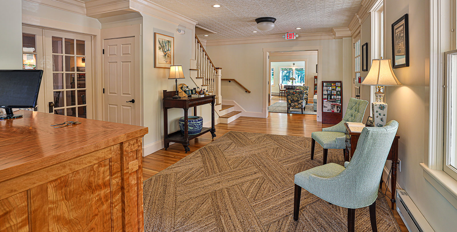 a room with a rug and chairs