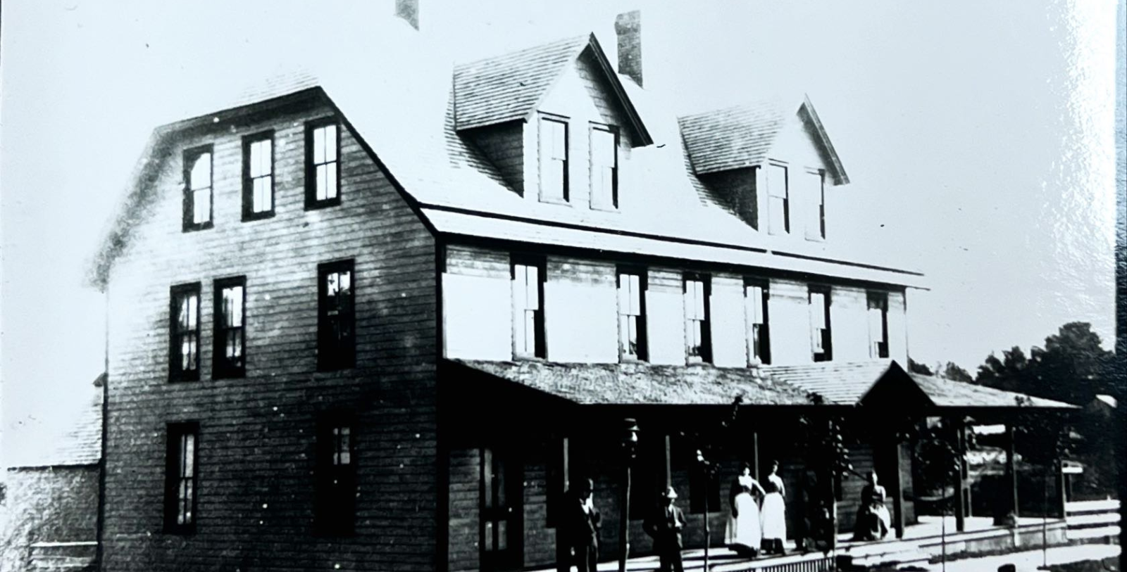 a group of people standing outside a house