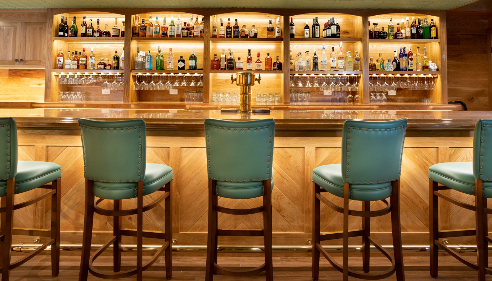 a bar with a row of chairs and a beer tap
