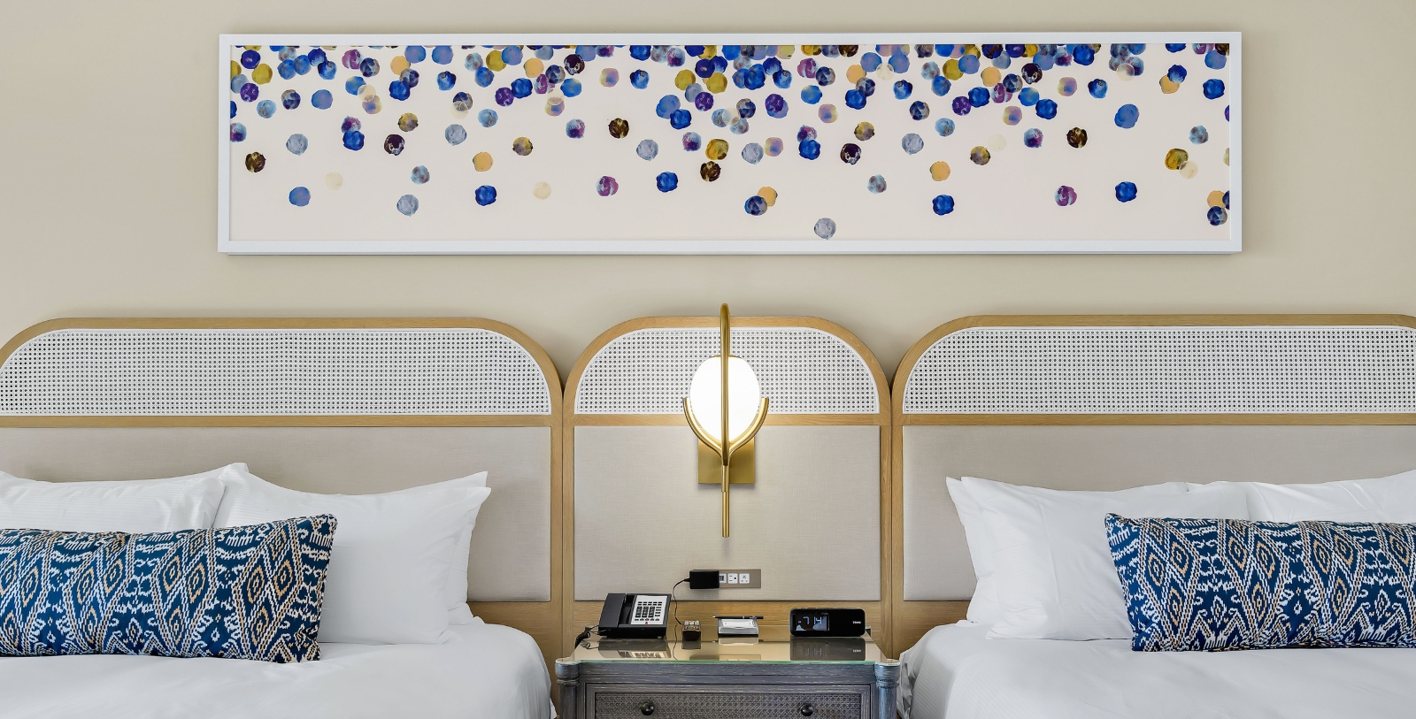 a room with two beds and a lamp