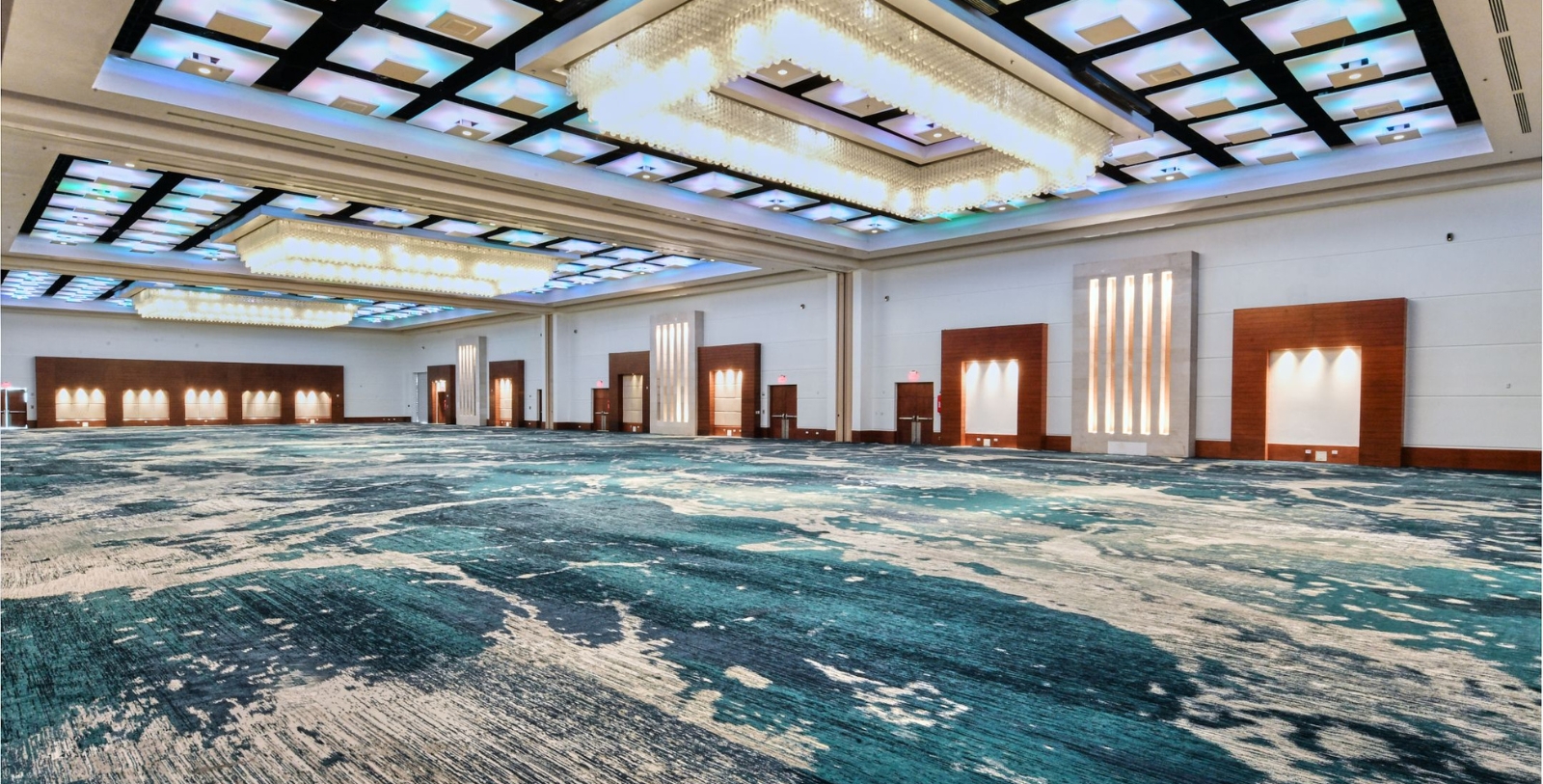 a large room with a blue carpet and lights
