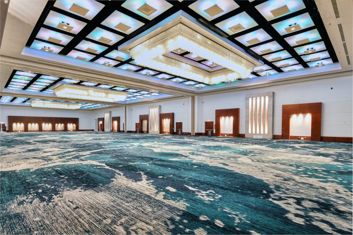 a large room with a blue carpet and lights