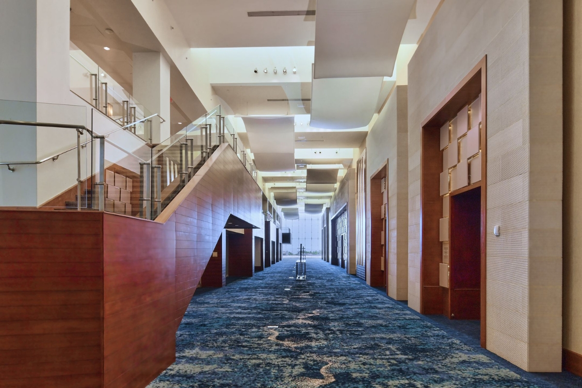 a hallway with stairs and a staircase