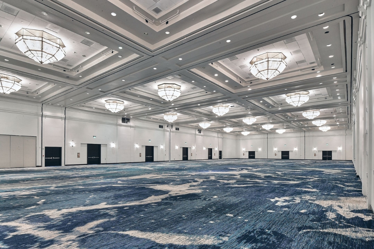 a large room with lights from the ceiling