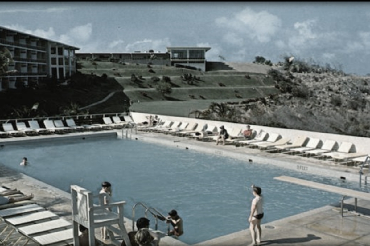 a pool with people sitting on chairs