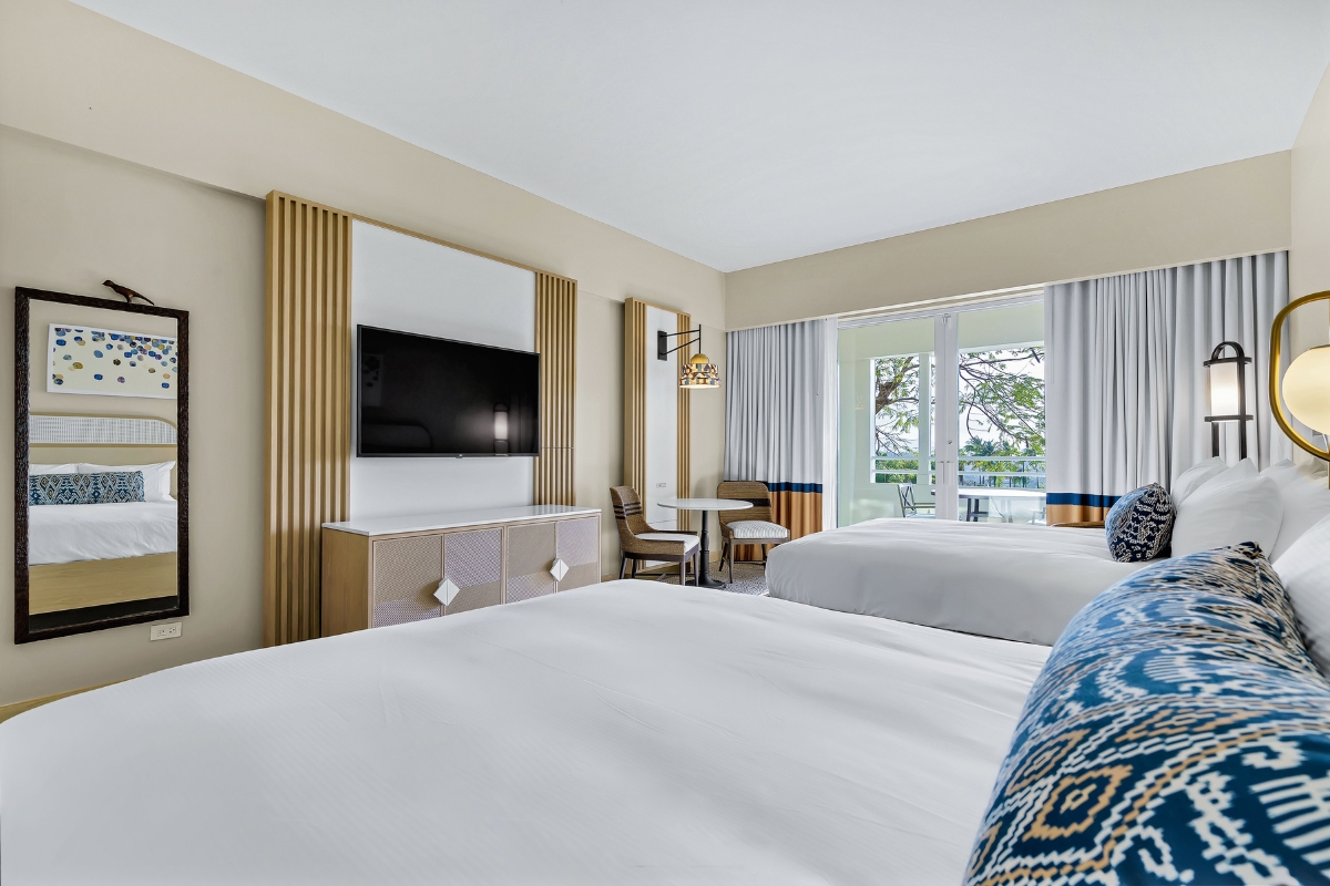 a room with two beds and a television