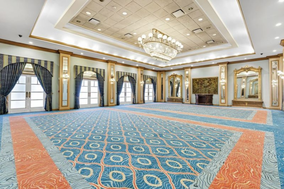 a large room with a chandelier and a mirror