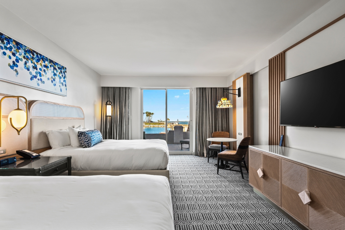 a room with two beds and a television