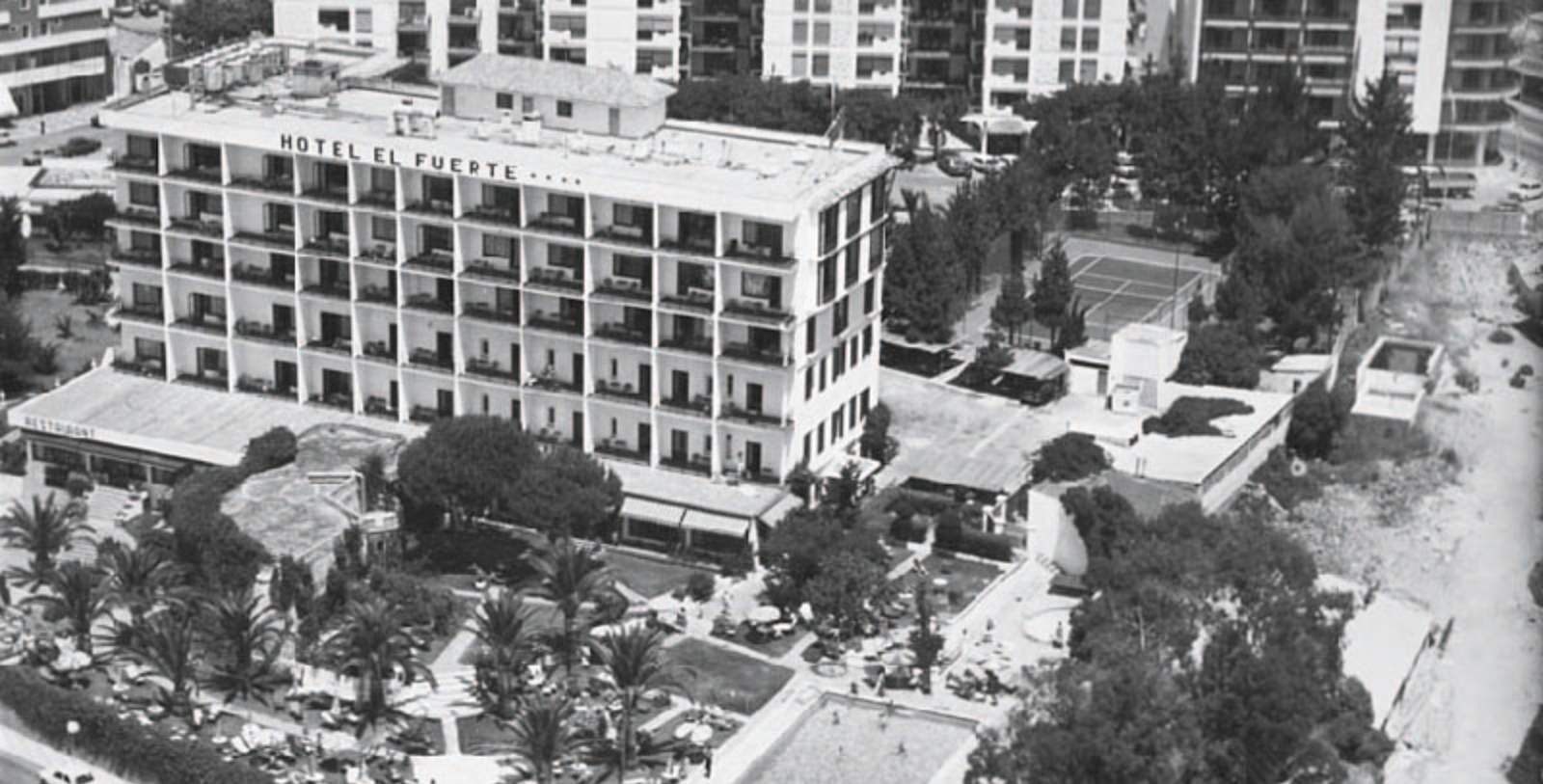 a building with many balconies and trees