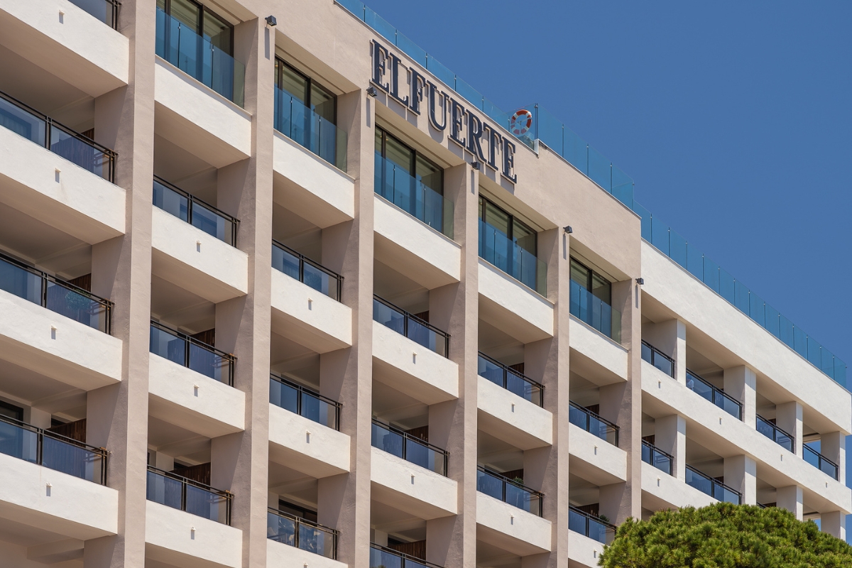 a building with balconies and a sign