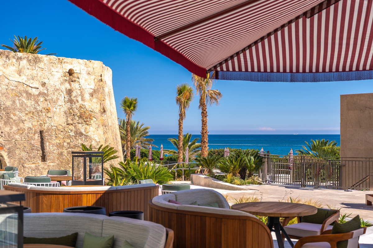 a beach with palm trees and chairs